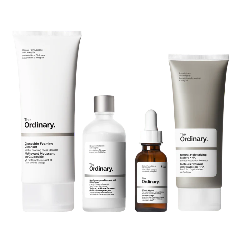 The Ordinary Refine & Regenerate Collection packaging showcasing four full-size products: Glucoside Foaming Cleanser, Saccharomyces Ferment 30% Milky Toner, GF 15% Solution, and Natural Moisturizing Factors + HA.