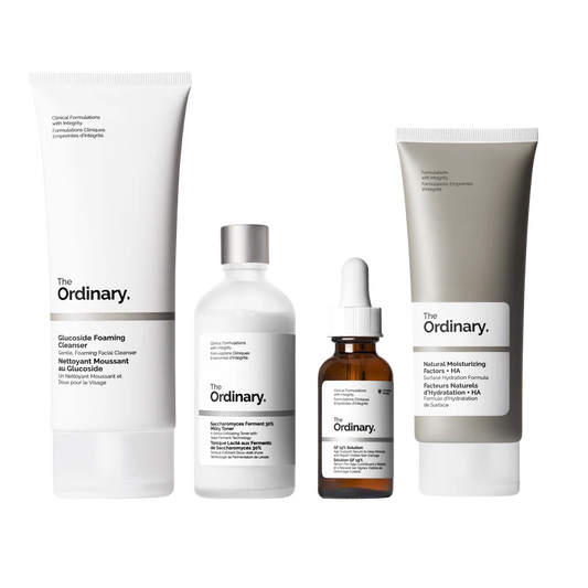 The Ordinary Refine & Regenerate Collection packaging showcasing four full-size products: Glucoside Foaming Cleanser, Saccharomyces Ferment 30% Milky Toner, GF 15% Solution, and Natural Moisturizing Factors + HA.