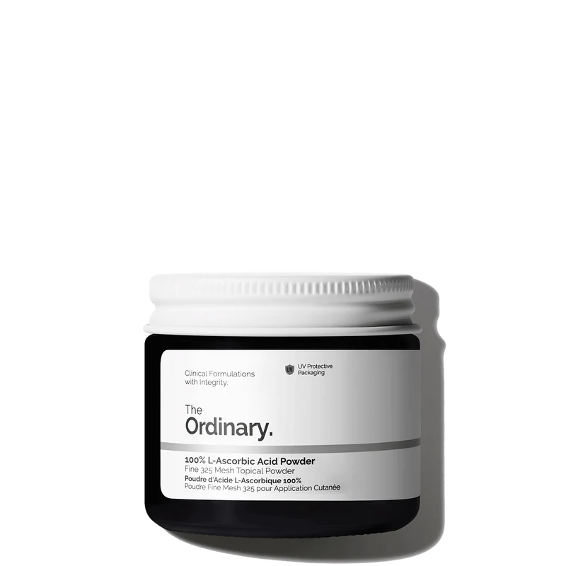 The Ordinary 100% L-Ascorbic Acid Powder in a 20g amber glass jar, including a small measuring spoon for easy mixing.