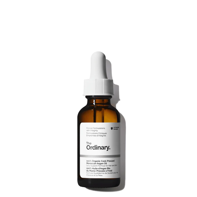 The Ordinary 100% Organic Cold-Pressed Moroccan Argan Oil 30ml amber glass bottle with a dropper, containing pure, unrefined golden oil for skin and hair.